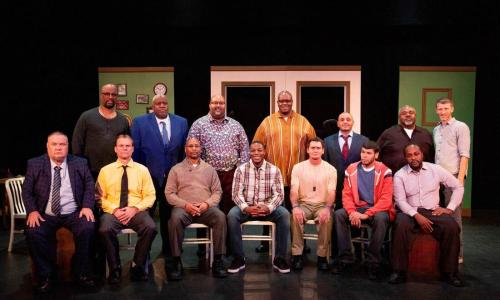 Group shot of Y-Haven residents lined up on stage