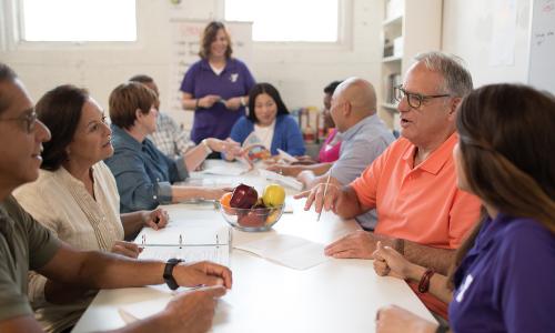 Diabetes prevention group around a table talking