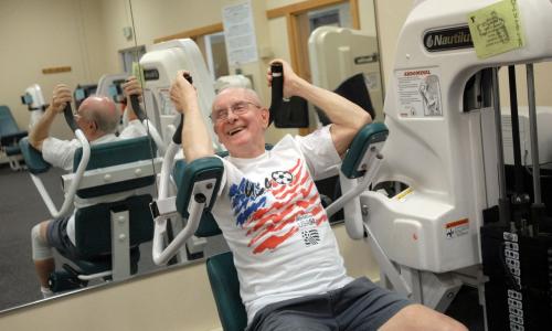 Senior member using abdominal machine