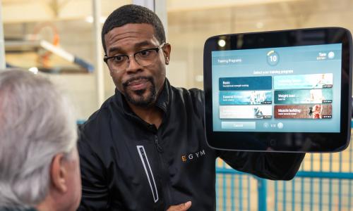 EGYM trainer coaches YMCA member