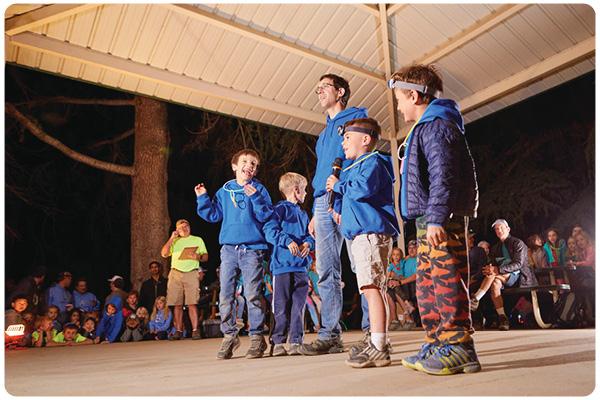 Parents and campers under pavilion singing songs 