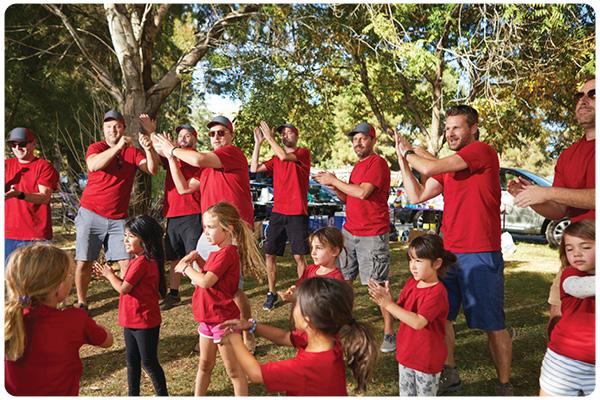 Parents and children outside stretching  