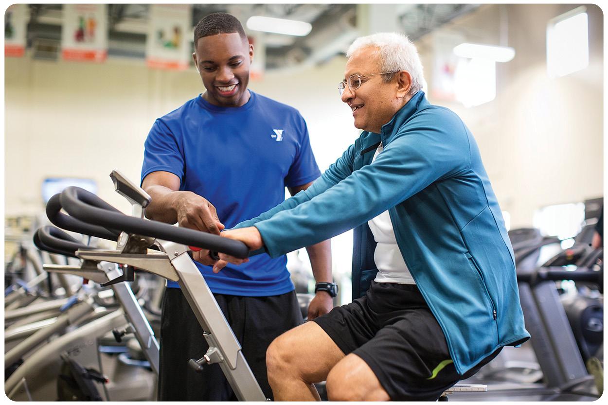 Personal Trainer guiding member on an exercise machine 