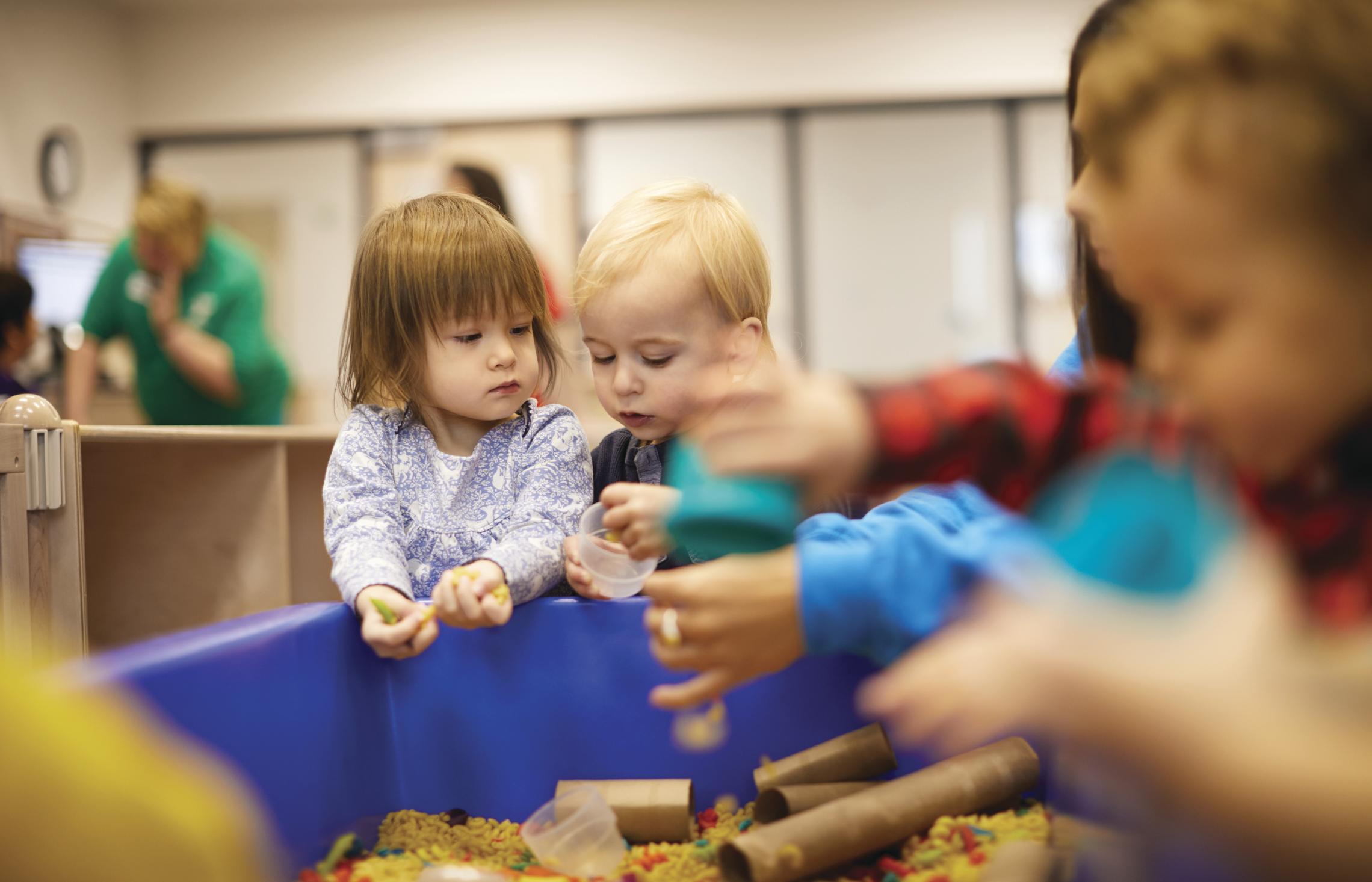 toddlers playing in sand box