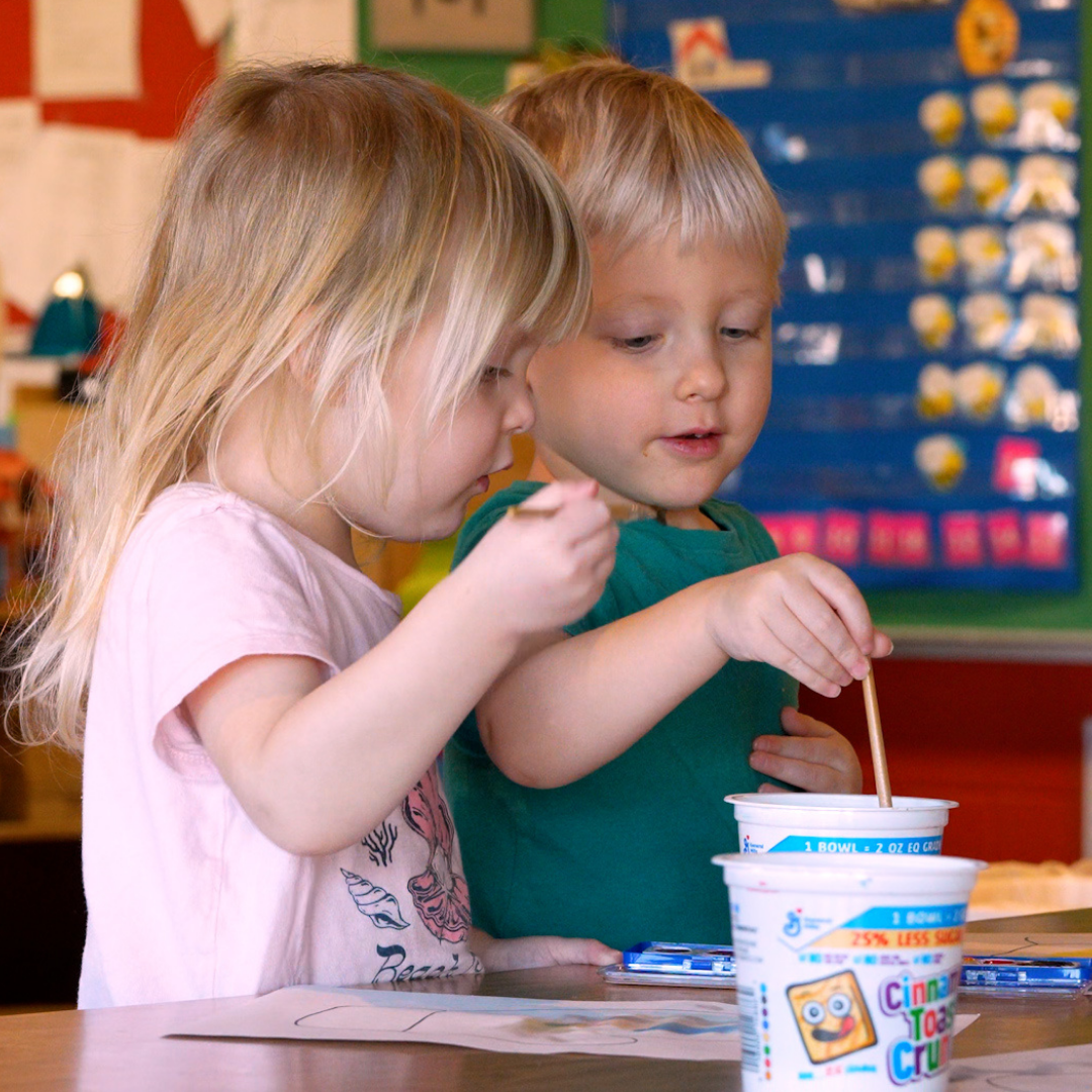 2 kids at preschool painting