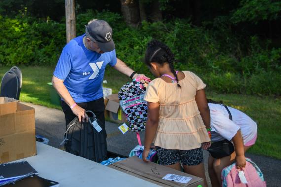 giving out backpacks