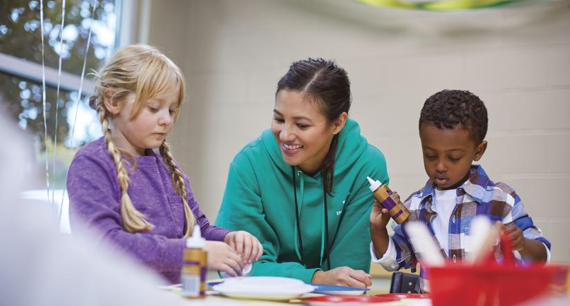 Y staff member engaging kids in an activity 