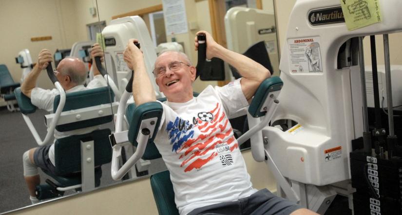 Senior member using abdominal machine