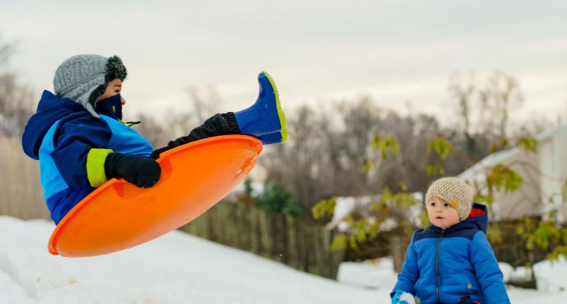 2 kids sledding