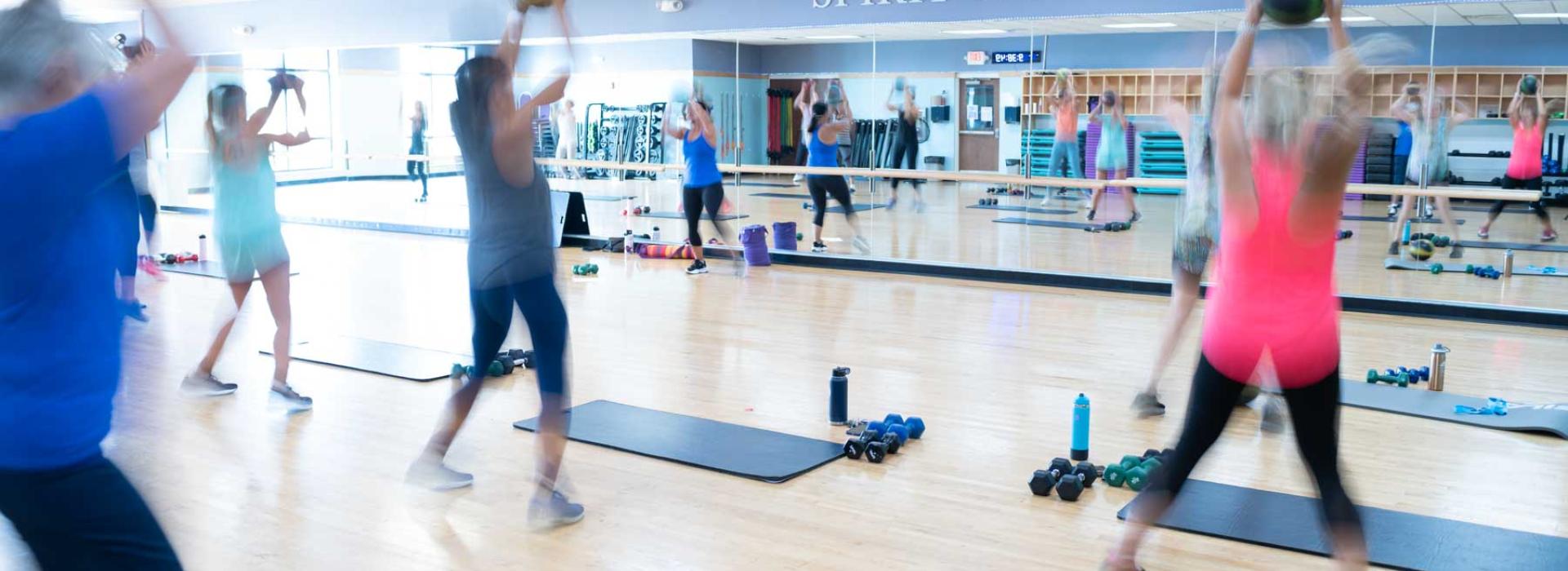 Exercise class showing members with weighted medicine balls.