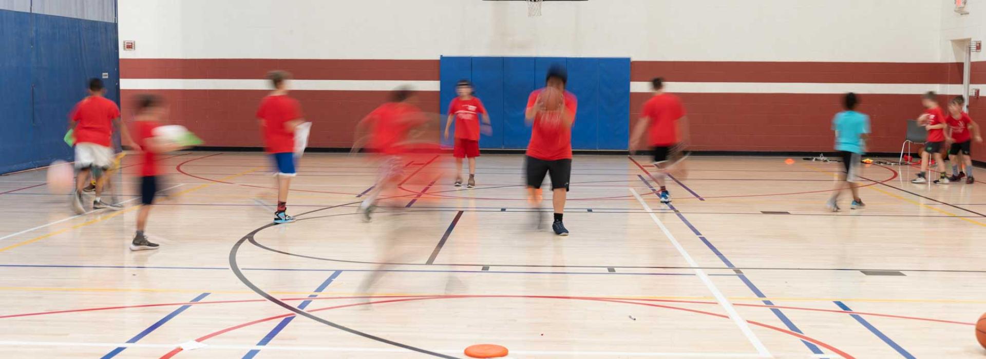 Kids playing basketball in gym